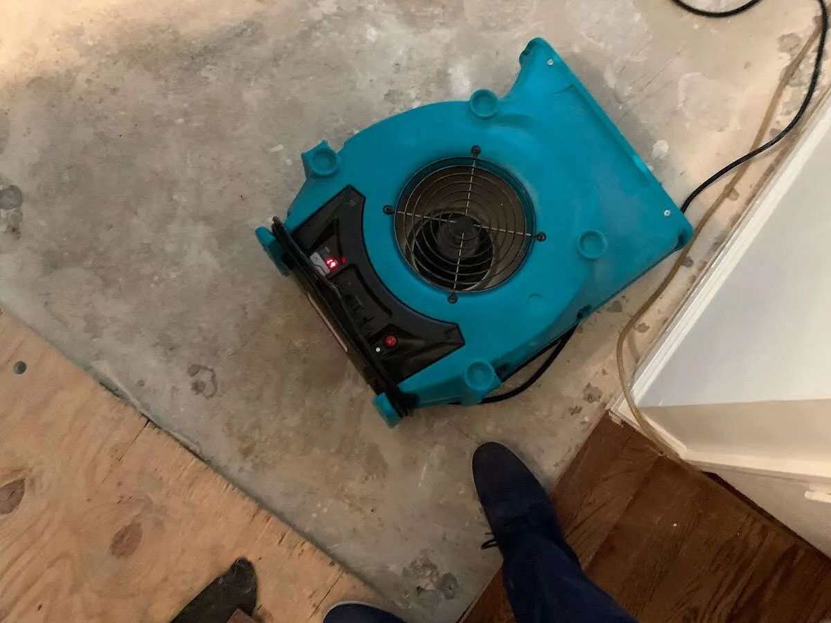 Air mover drying subfloor during Commercial Water Damage Restoration in Wahpeton